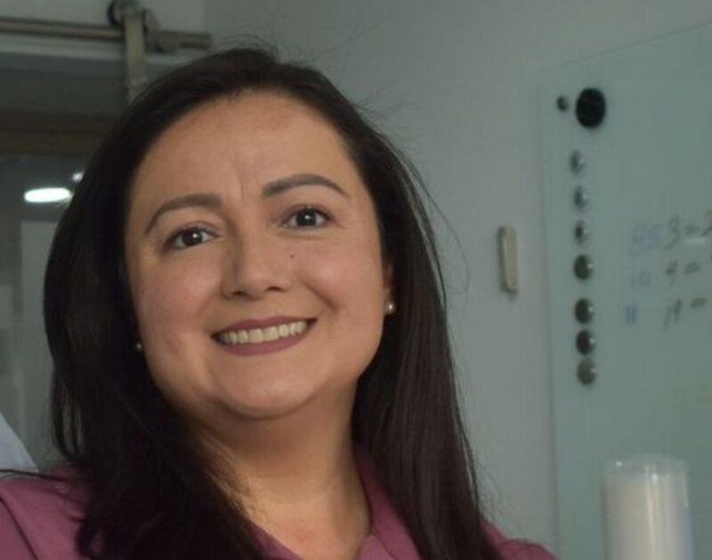 Dr. Elena Marquez smiling in a treatment room