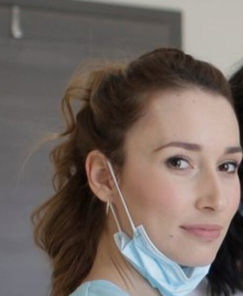 Hannah Brooks, a hygienist in light blue scrubs