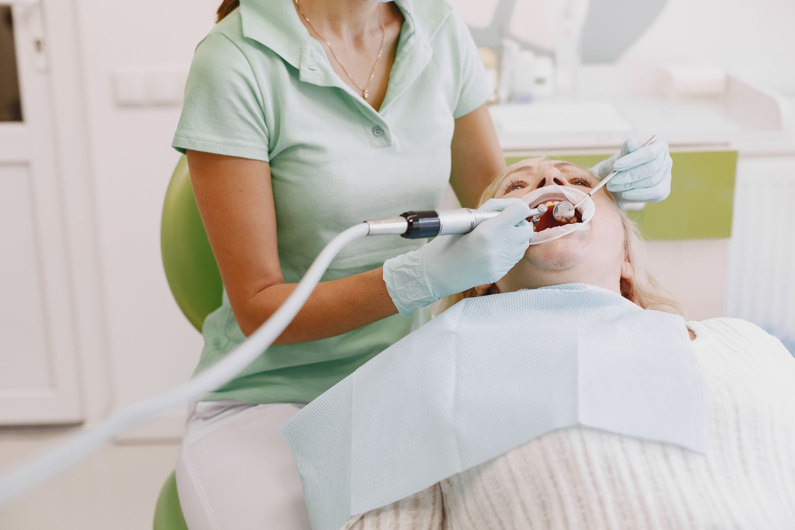 A hygienist cleaning a patient’s teeth
